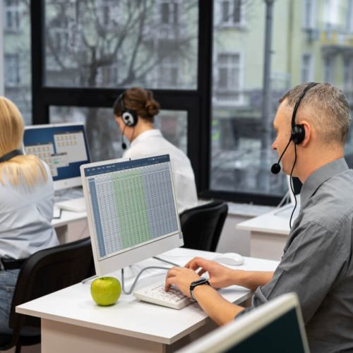 colleagues-working-together-call-center-with-headphones (1)